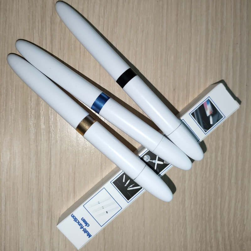 Headphone Cleaning Pen Earplugs in various colors with packaging on a wooden surface.